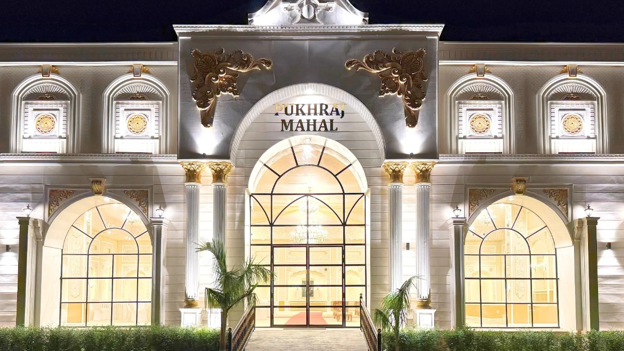 The floodlit Pukhraj Mahal entrance portico after dark